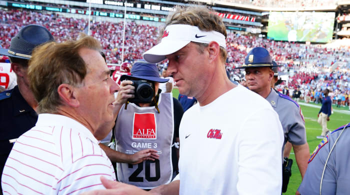 Alabama Crimson Tide head coach Nick Saban greets Mississippi Rebels head coach Lane Kiffin at midfield after a game.